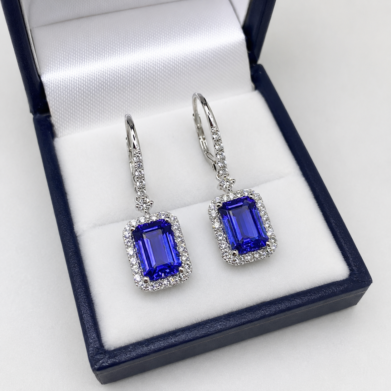 AAA grade emerald cut tanzanite earrings with diamonds in 14k white gold featuring vivid blue-violet natural tanzanites.