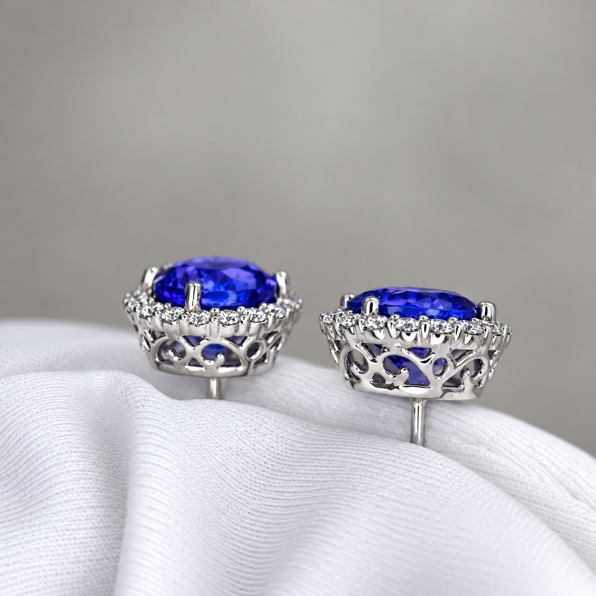 Exceptional Tanzanite (+6 Carat) and Diamond Halo Stud Earrings – 18ct White Gold