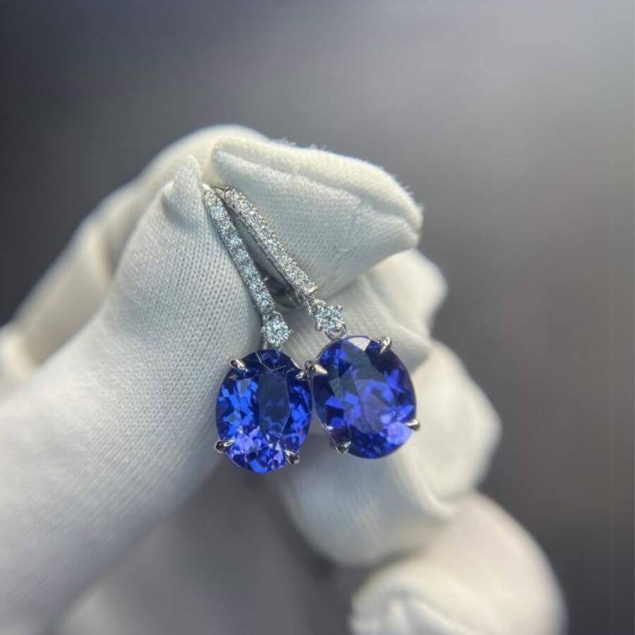Natural tanzanite drop earrings, with diamonds set in white gold.